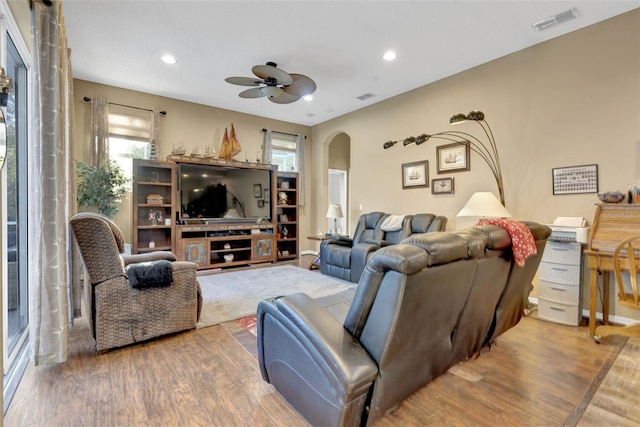 living room with hardwood / wood-style flooring and ceiling fan