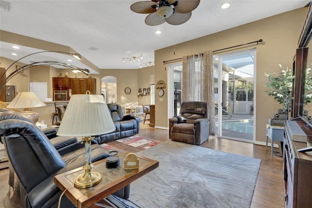 living room featuring light wood-type flooring and ceiling fan