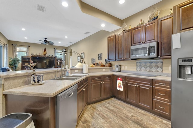 2533 Wood Pointe Dr, Holiday, FL 34691 - kitchen with stainless steel appliances, a sink, a peninsula, ceiling fan, and light countertops