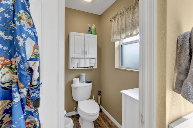 2533 Wood Pointe Dr, Holiday, FL 34691 - full bathroom with wood finished floors, toilet, baseboards, and vanity