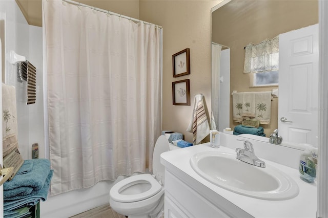 full bathroom with vanity, shower / bath combo with shower curtain, and toilet