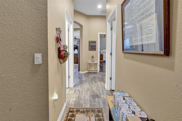 hall with hardwood / wood-style flooring