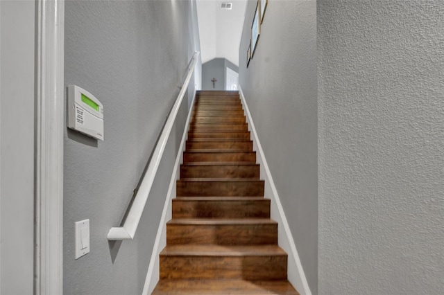 stairs featuring hardwood / wood-style flooring