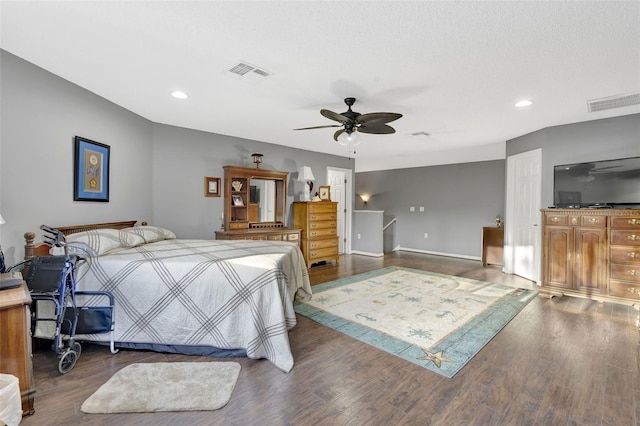 bedroom with ceiling fan and dark hardwood / wood-style floors