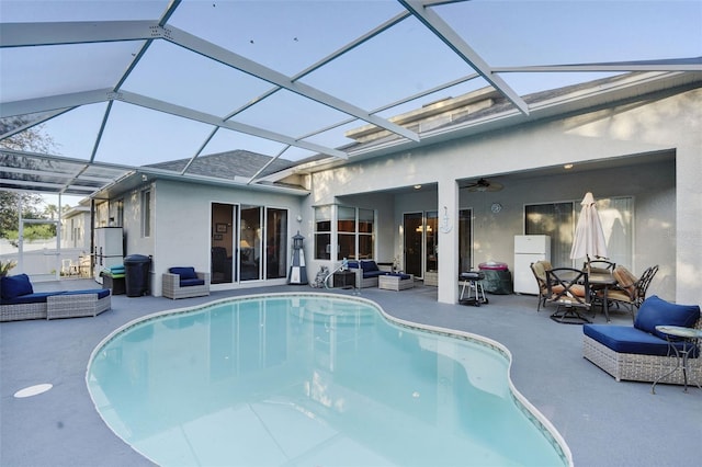 view of pool featuring ceiling fan, a lanai, outdoor lounge area, and a patio