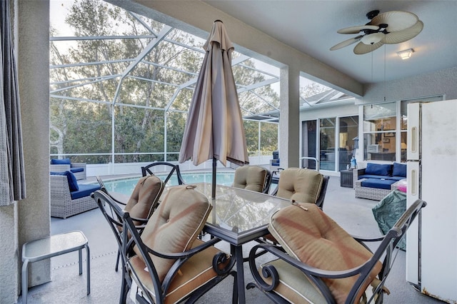 sunroom / solarium with ceiling fan and a pool