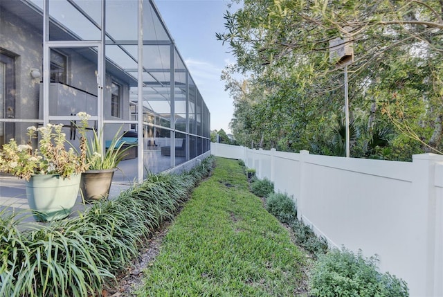 view of yard featuring glass enclosure