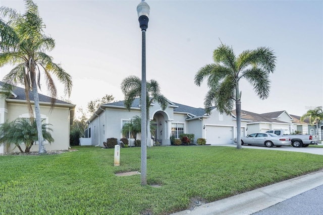 single story home with a garage and a front yard