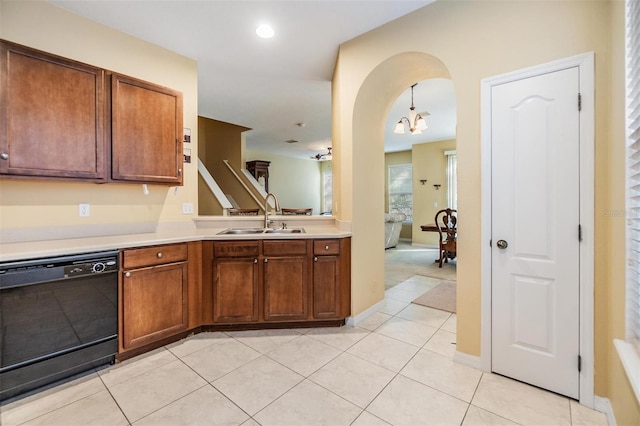 kitchen featuring black dishwasher, sink, a chandelier, light tile patterned flooring, and decorative light fixtures