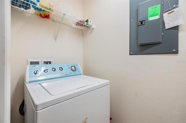 clothes washing area with washer / clothes dryer and electric panel