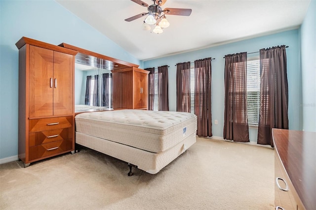 carpeted bedroom featuring ceiling fan and vaulted ceiling