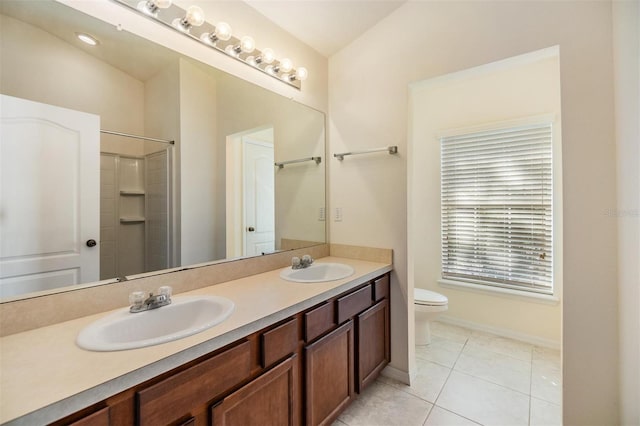 bathroom featuring vanity, tile patterned flooring, toilet, and vaulted ceiling