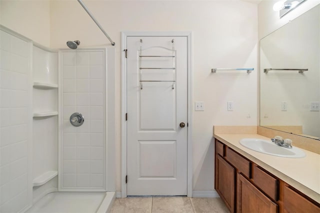 bathroom featuring vanity, tile patterned floors, and a shower