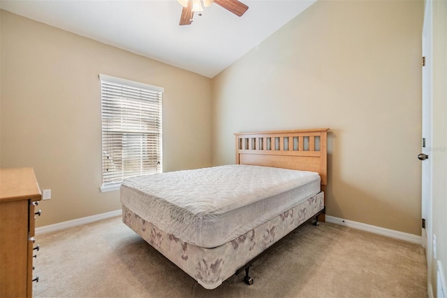 bedroom featuring ceiling fan, lofted ceiling, and light colored carpet