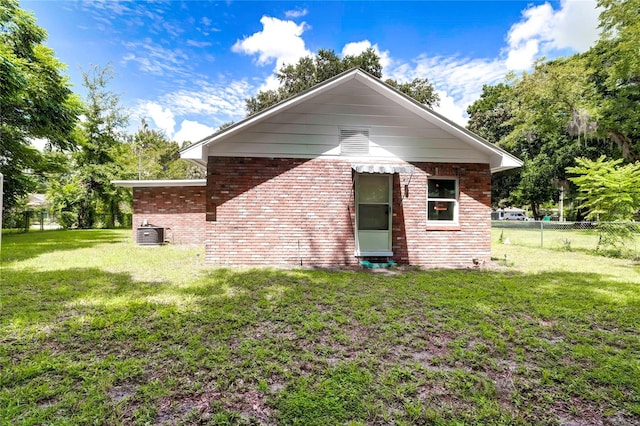 rear view of property featuring a yard