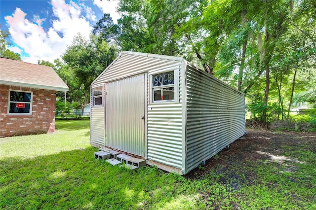 view of outbuilding with a yard