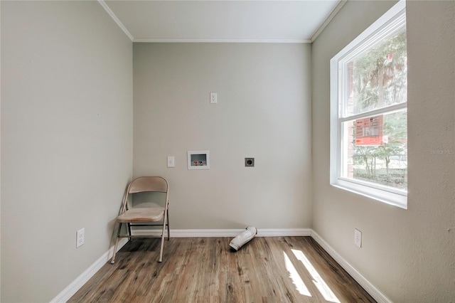 clothes washing area featuring hardwood / wood-style floors, washer hookup, hookup for an electric dryer, and crown molding