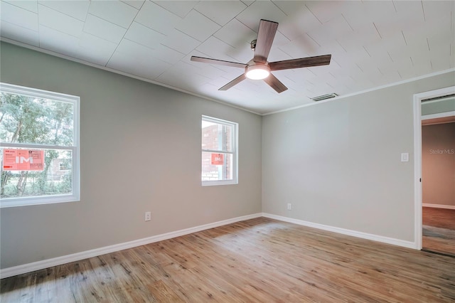 empty room featuring ornamental molding, light hardwood / wood-style flooring, and ceiling fan