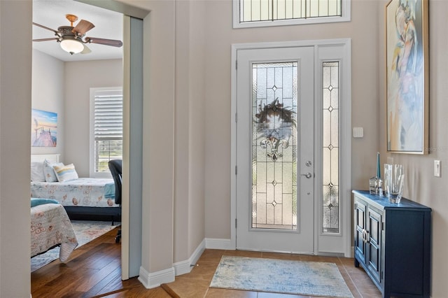 foyer entrance with light hardwood / wood-style floors and ceiling fan