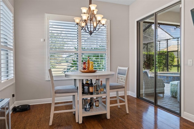 dining area with a chandelier and dark hardwood / wood-style floors