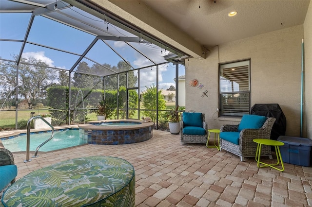 view of patio featuring a swimming pool with hot tub and a lanai