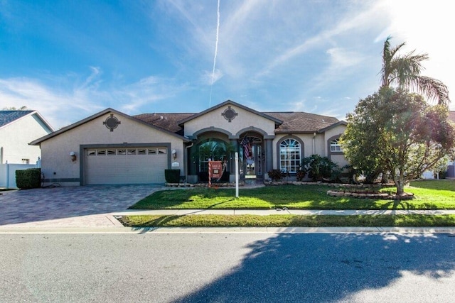 ranch-style house with a garage and a front yard