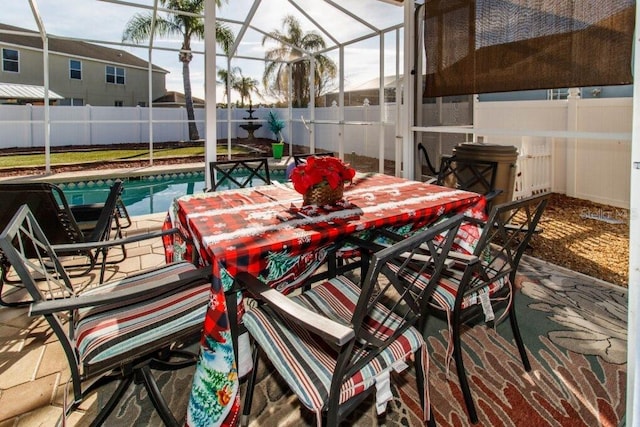 view of patio / terrace featuring a fenced in pool and glass enclosure