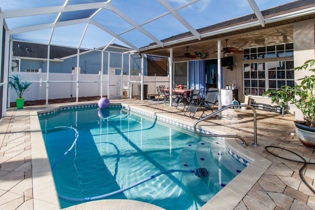 view of swimming pool with a lanai, ceiling fan, and a patio