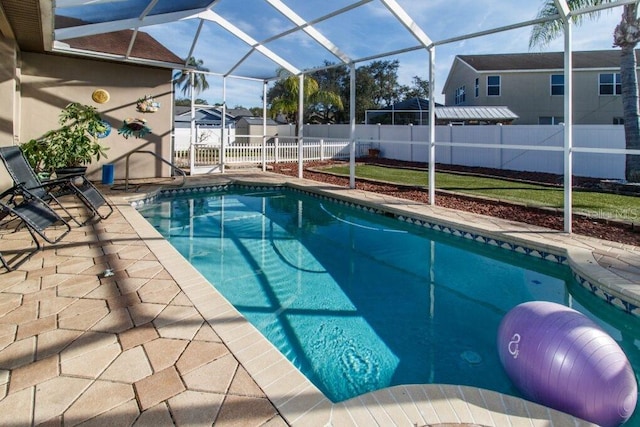 view of pool featuring a patio and glass enclosure