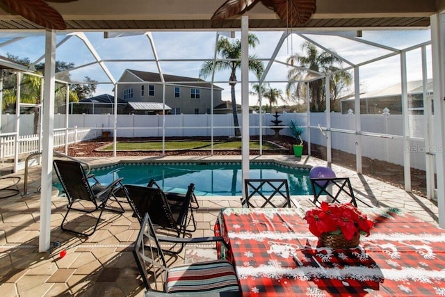 view of pool with a patio area and a lanai