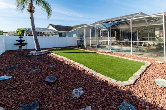 view of yard with glass enclosure and a fenced in pool