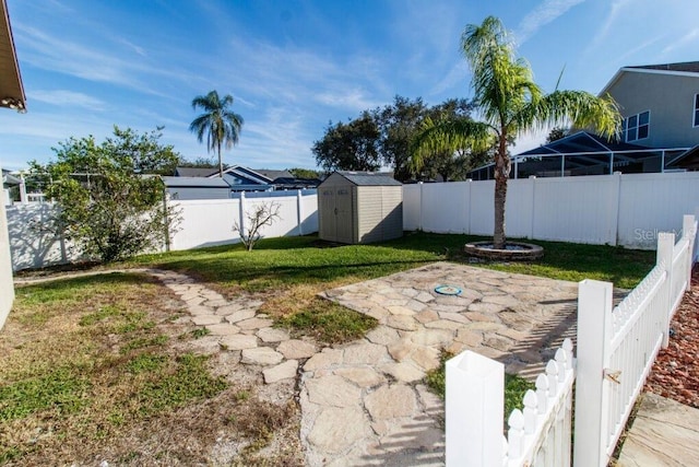 view of yard featuring a storage shed and a patio