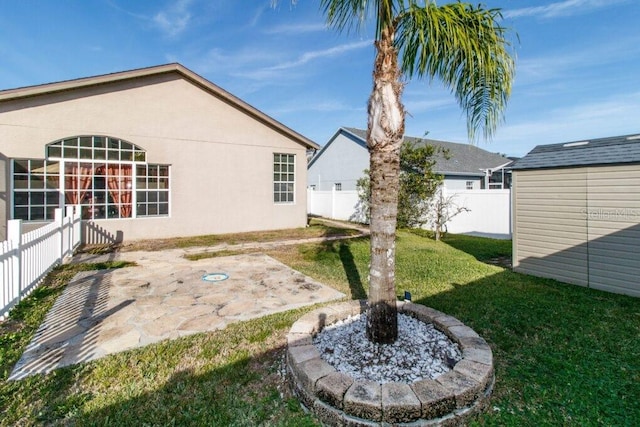 view of yard with a patio area and a storage shed