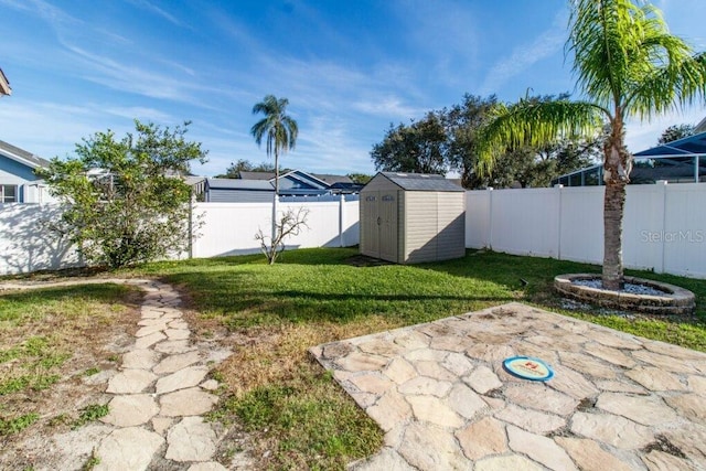 view of yard featuring a patio and a storage shed