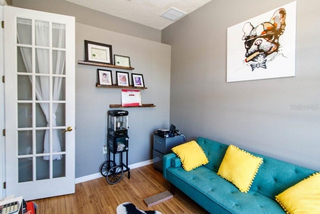 living area with hardwood / wood-style floors