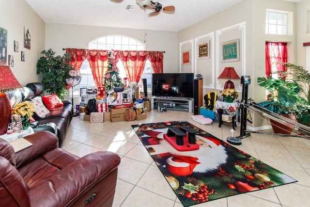 tiled living room with ceiling fan and plenty of natural light