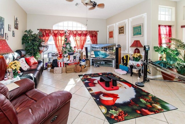 living room with tile patterned floors, ceiling fan, and a healthy amount of sunlight