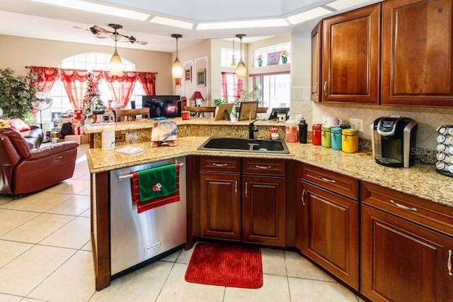 kitchen featuring dishwasher, kitchen peninsula, hanging light fixtures, and sink