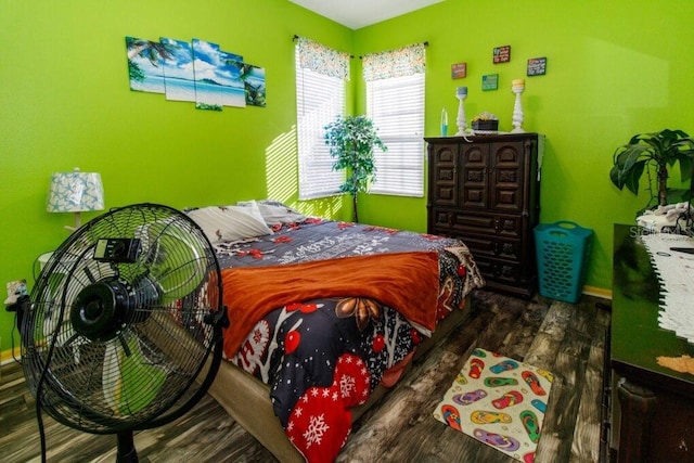 bedroom with dark hardwood / wood-style flooring