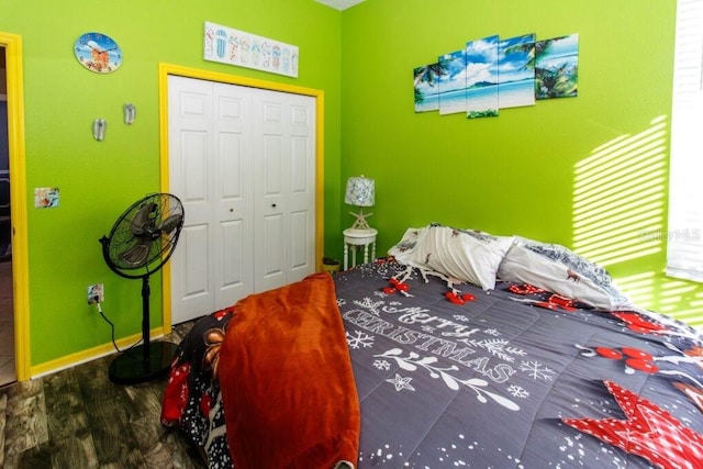 bedroom with hardwood / wood-style flooring and a closet