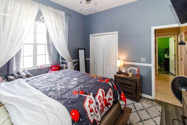 bedroom with hardwood / wood-style floors and a closet