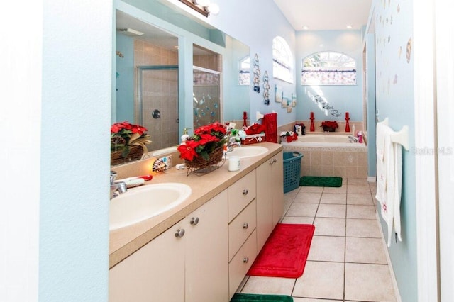 bathroom featuring plus walk in shower, tile patterned flooring, and vanity