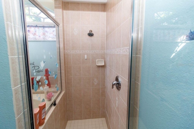 bathroom featuring a shower with door