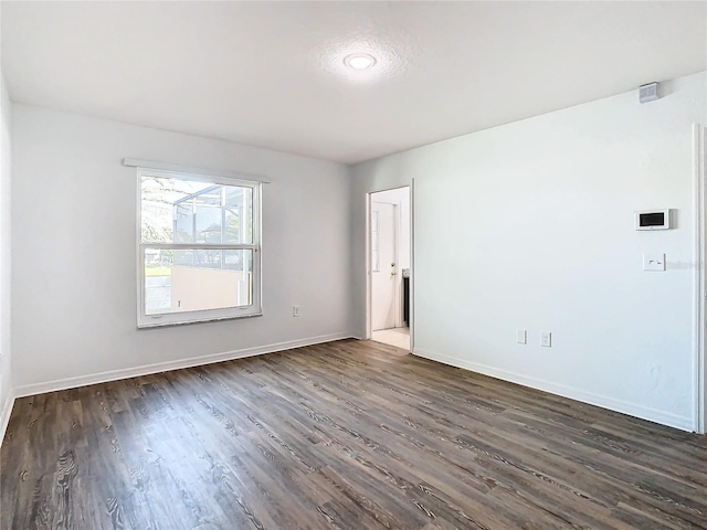 unfurnished room featuring dark hardwood / wood-style flooring