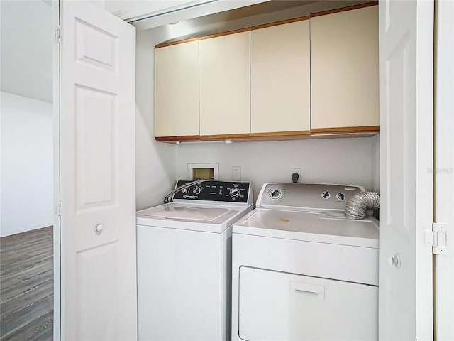 laundry area with cabinets, independent washer and dryer, and hardwood / wood-style flooring