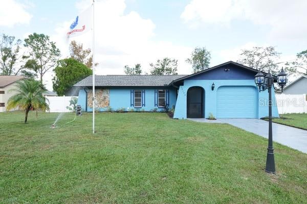 ranch-style home with a garage and a front yard