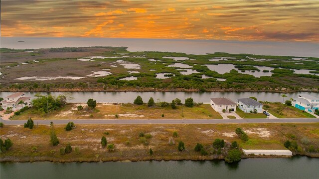 aerial view at dusk with a water view