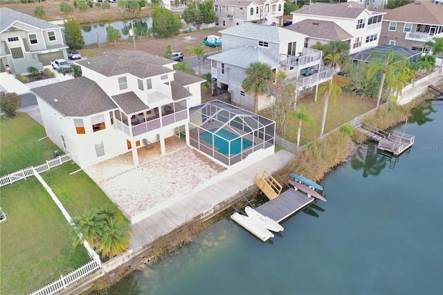 birds eye view of property featuring a water view and a residential view