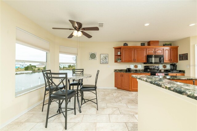 kitchen with visible vents, brown cabinetry, a water view, black appliances, and open shelves