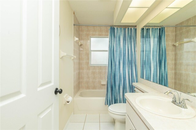 full bathroom with toilet, shower / tub combo, vanity, and tile patterned floors